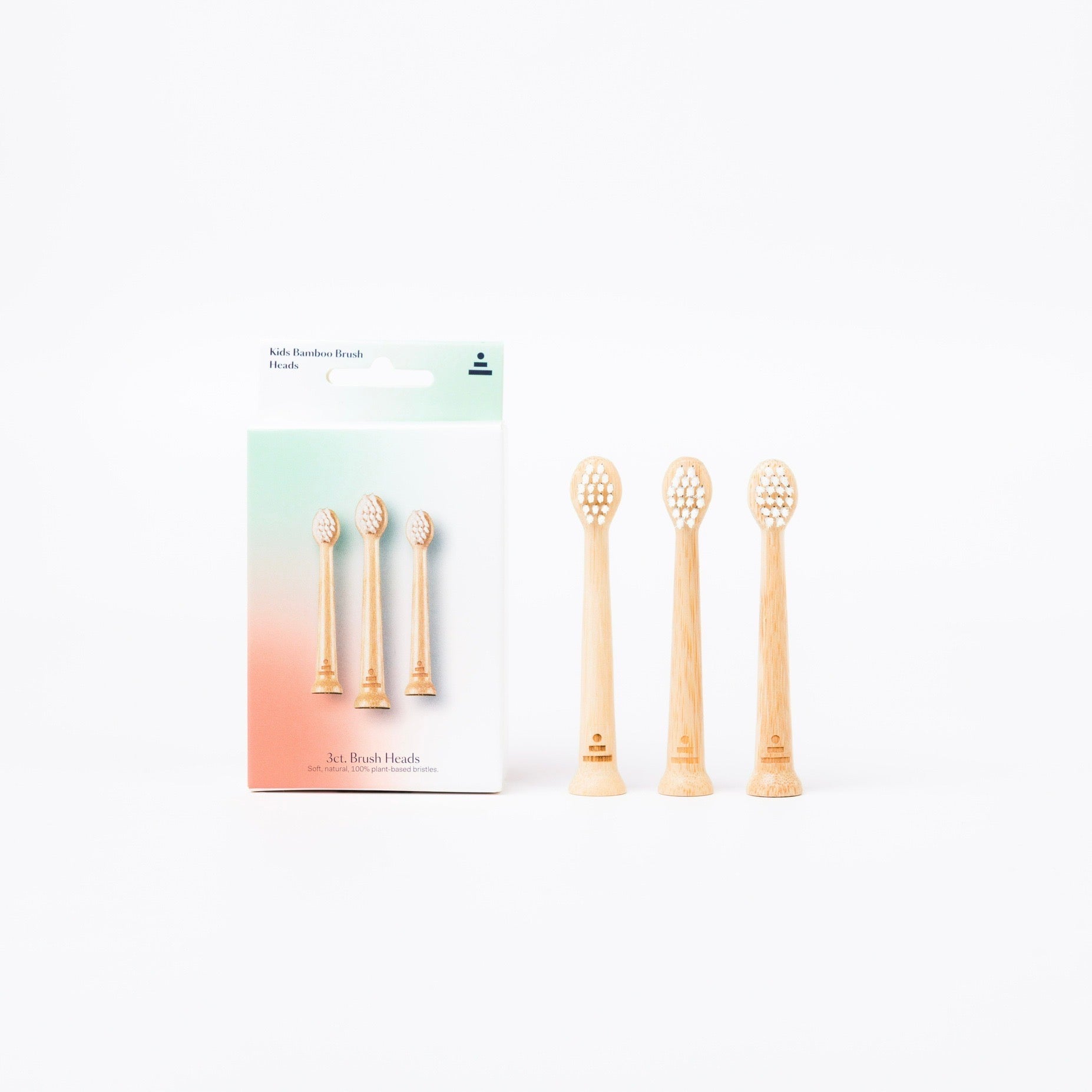 Four natural bamboo replacement toothbrush heads displayed next to their white and pastel gradient retail packaging box on a clean white background.